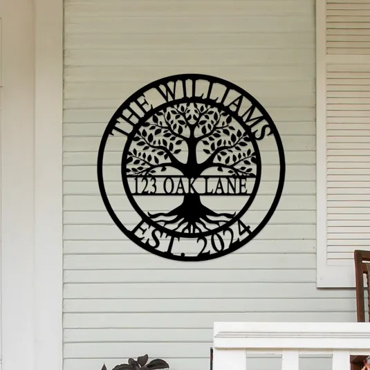Metal wall sign featuring a tree design with text \“The Williams, 123 Oak Lane, Est. 2024\“ displayed on a house exterior.