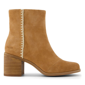 A tan suede ankle boot with a fringe detail on the side and a stacked heel.