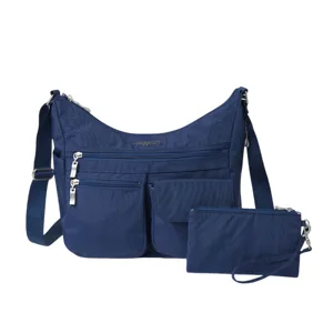 A blue crossbody bag with multiple zippered compartments and an adjustable strap, accompanied by a matching wristlet pouch.