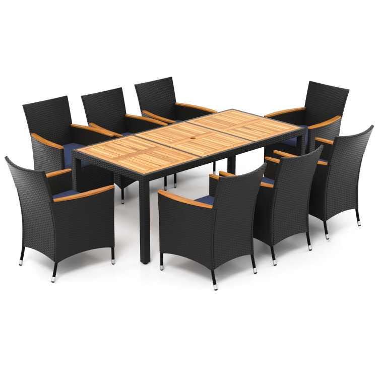 Outdoor dining set with a rectangular table and eight wicker armchairs. The table has a wooden top with a geometric pattern, and the chairs feature light wooden armrests.
