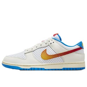 Nike Dunk Low Retro SE Shoes feature a perforated white leather upper, yellow-to-red gradient swoosh, blue accents on the outsole and lining, and cream midsole for a stylish look.