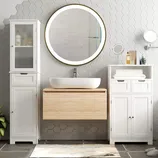 Modern bathroom setting with a wooden floating vanity, white ceramic vessel sink, circular LED mirror, hexagonal tile wall, and white cabinets for storage.