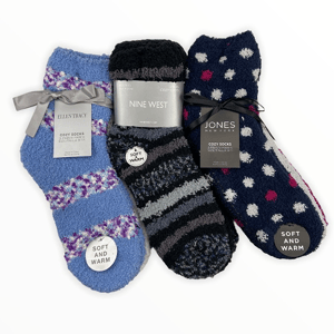 Three pairs of cozy, soft, and warm socks from Ellen Tracy, Nine West, and Jones New York, each with unique patterns: blue with purple stripes, black and gray stripes, and navy with pink and white polka dots.