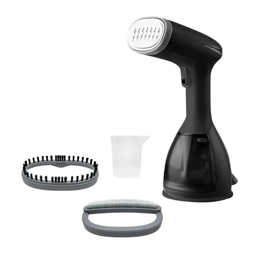 A handheld garment steamer with two detachable brush attachments and a measuring cup for water.