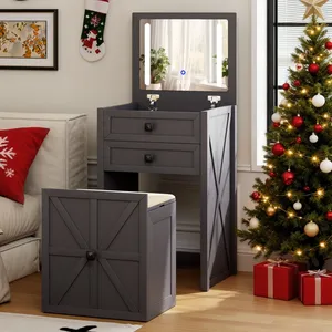 Dark gray vanity set with a foldable mirror and two drawers, accompanied by a matching cushioned stool. Decorated space with a Christmas tree, red and white ornaments, and gift boxes nearby.