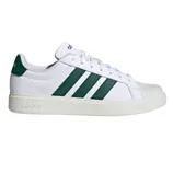 A white Adidas sneaker featuring three green stripes on the side, with \“adidas\“ branding on the heel and midsole.