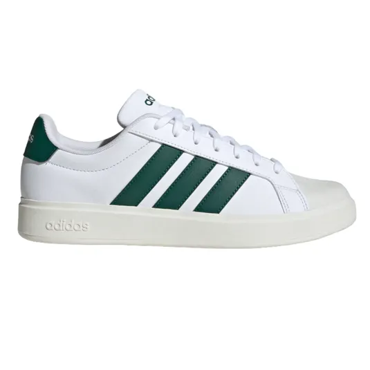 A white Adidas sneaker featuring three green stripes on the side, with \“adidas\“ branding on the heel and midsole.