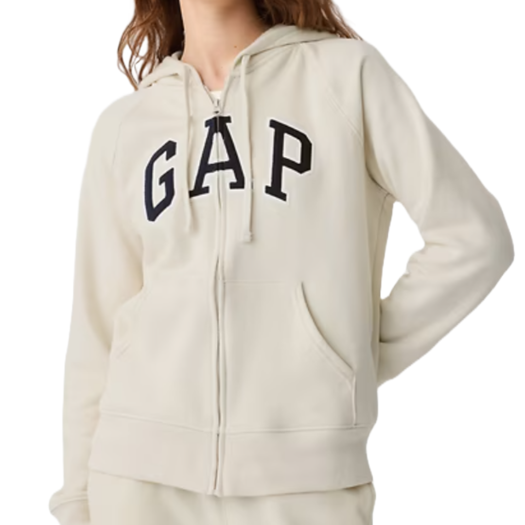 Cream-colored zip-up hoodie with \“GAP\“ in bold black letters on the chest, featuring a hood with drawstrings and front pockets.