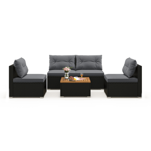 Outdoor patio furniture set with gray cushions, featuring a three-seater sofa, two single chairs, and a coffee table with a wooden top, decorated with flowers, fruit, and drinks.