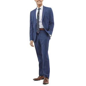 A person wearing a blue suit with a white shirt, patterned tie, brown belt, and brown shoes.