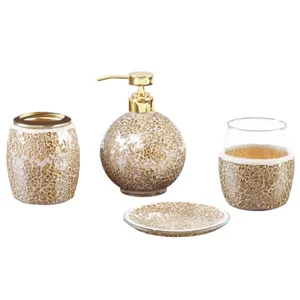 Bathroom accessory set featuring a soap dispenser, tumbler, toothbrush holder, and soap dish, all with a mosaic design in gold and white with a glossy finish.