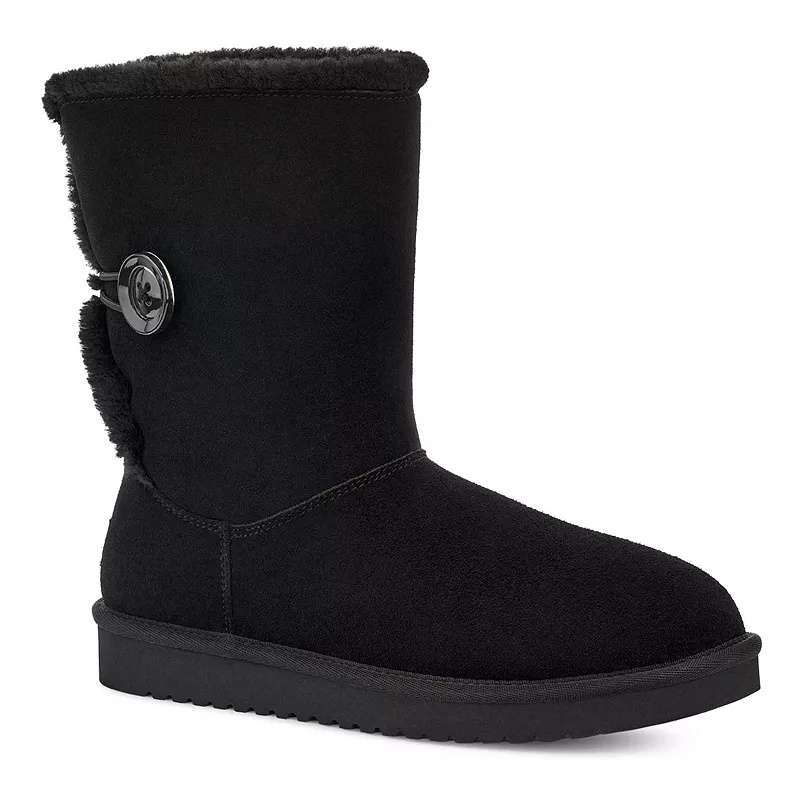 Koolaburra by UGG Nalie Boots are black with a mid-calf height and feature a large button detail on the side. They have a suede exterior and a plush lining for added warmth and comfort.