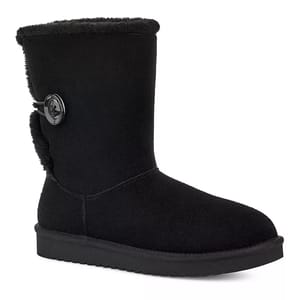 Koolaburra by UGG Nalie Boots are black with a mid-calf height and feature a large button detail on the side. They have a suede exterior and a plush lining for added warmth and comfort.