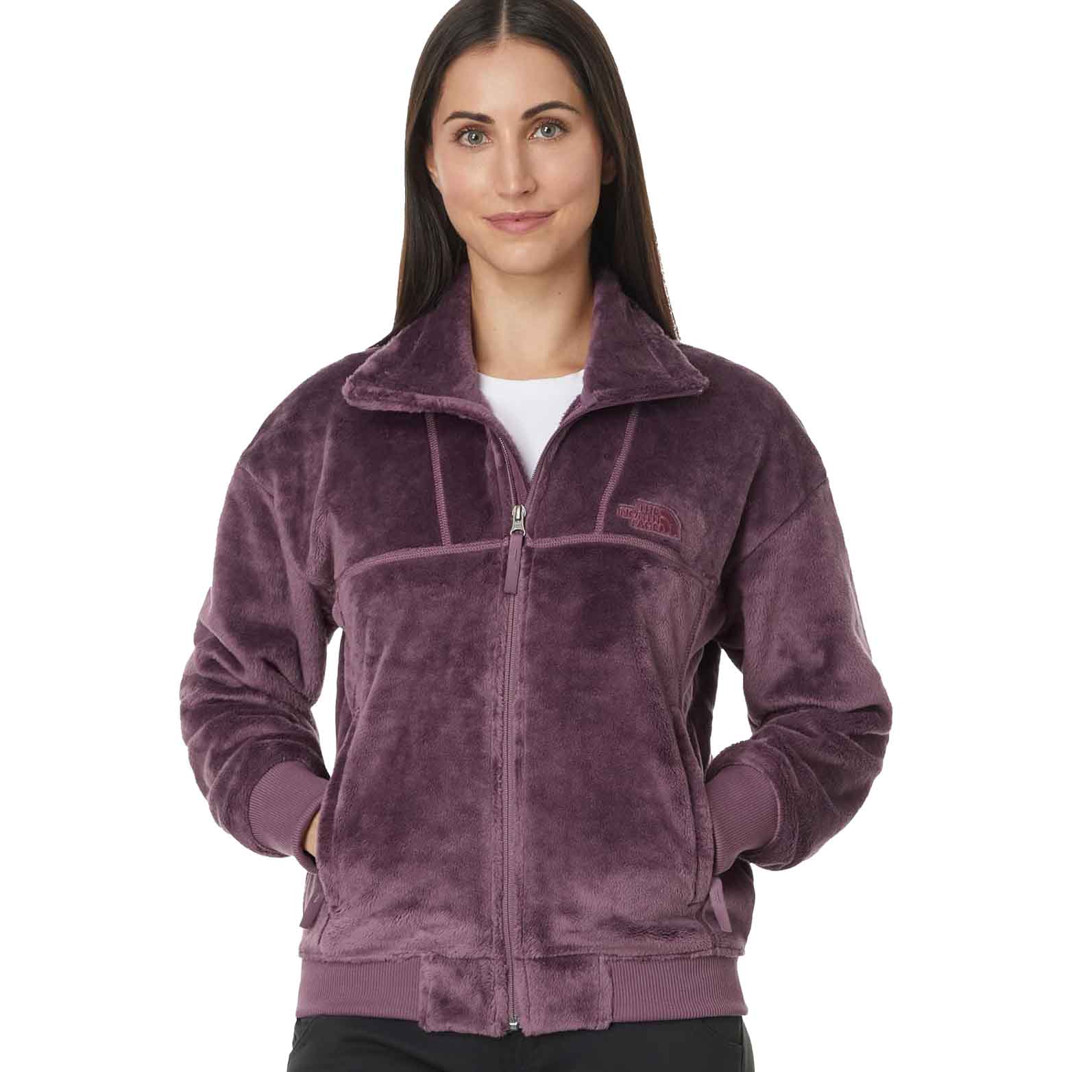 A plush, purple fleece jacket from The North Face featuring a full zip, high collar, two front pockets, and logo on the chest.