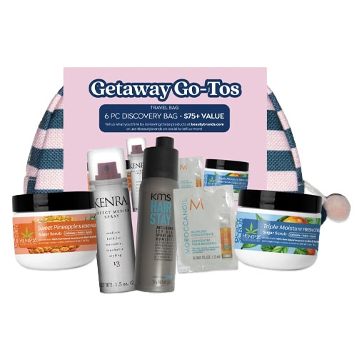 A travel bag titled \“Getaway Go-Tos\“ includes six beauty and hair care items: Kenra hairsprays, KMS HairStay, Moroccanoil treatment, Hempz body scrubs in Sweet Pineapple & Honey Melon and Triple Moisture scents, with a checkered pouch.