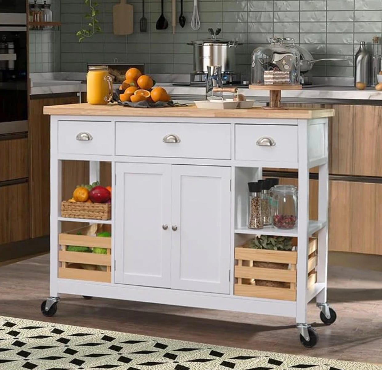 A white kitchen island on wheels with a wooden countertop, drawers, cabinets, and side shelves.