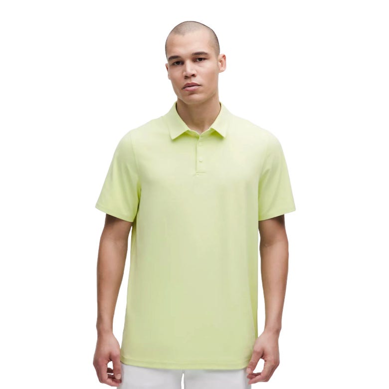 A person is wearing a light green polo shirt.