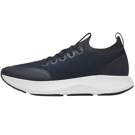 A navy athletic shoe with a textured upper and white cushioned sole, featuring laces and a pull tab at the heel.