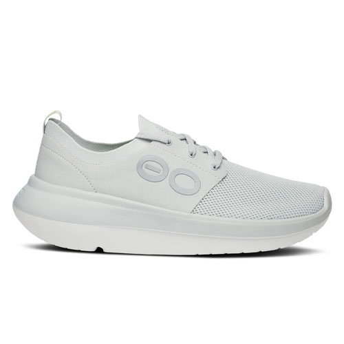 A white sneaker with a streamlined design, featuring a mesh upper and circular side accents.