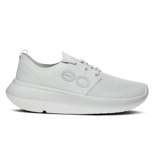 A white sneaker with a streamlined design, featuring a mesh upper and circular side accents.