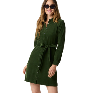 A woman wearing a green long-sleeve button-up dress with a tied waist and sunglasses.