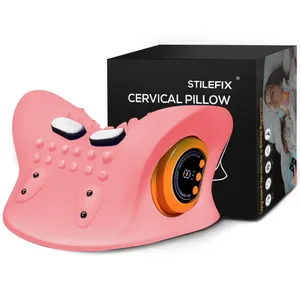 Pink cervical pillow with massaging features, including knobs and electronic controls, shown beside its packaging.