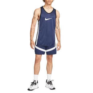 Navy blue Nike Dri-Fit basketball shorts with white diagonal stripes, designed for comfort and performance. They are paired with a matching navy tank top, featuring a prominent white Nike swoosh.