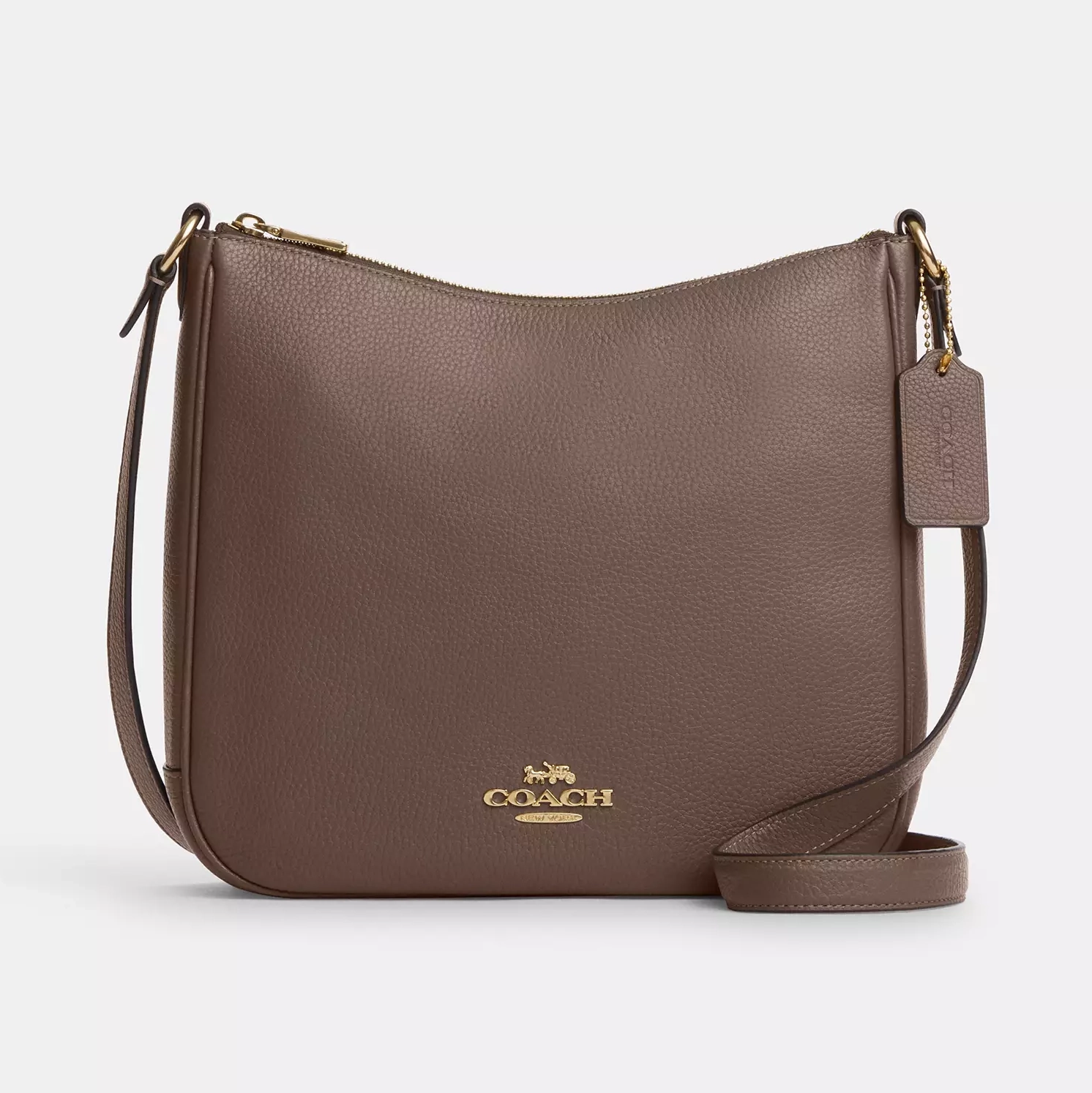A brown Coach crossbody bag with a shoulder strap and gold-tone logo on the front.