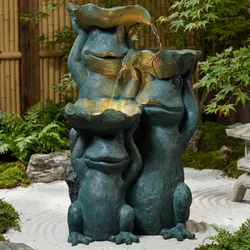 Three whimsical frog sculptures hold large leaves, forming a cascading fountain, set within a serene garden environment.