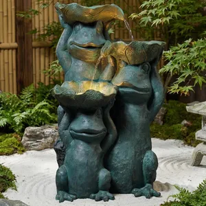 Three whimsical frog sculptures hold large leaves, forming a cascading fountain, set within a serene garden environment.