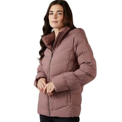A woman is wearing a mauve quilted puffer jacket with a zip front and faux fur-lined collar.