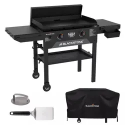 Blackstone outdoor griddle with dual burners, adjustable legs, side shelves, and a grease tray, accompanied by a spatula, a meat press, and a protective cover.