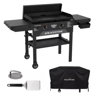 Blackstone outdoor griddle with dual burners, adjustable legs, side shelves, and a grease tray, accompanied by a spatula, a meat press, and a protective cover.