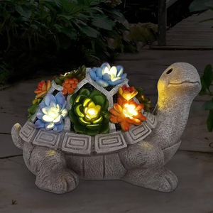 A decorative turtle garden light features colorful flowers on its shell that illuminate, creating a vibrant and whimsical outdoor ornament.