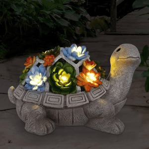 A decorative turtle garden light features colorful flowers on its shell that illuminate, creating a vibrant and whimsical outdoor ornament.