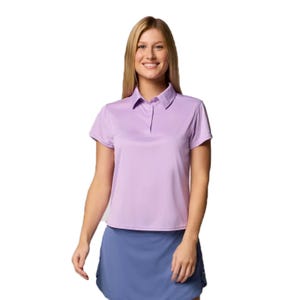 A person is wearing a light purple short-sleeve polo shirt paired with a blue skirt.