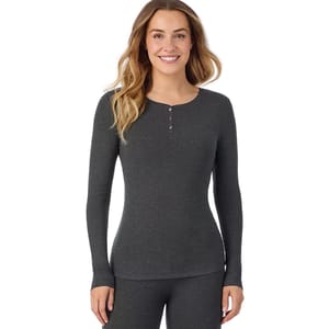 A woman is wearing a long-sleeve, dark gray ribbed thermal top with a henley neckline, paired with matching bottoms.