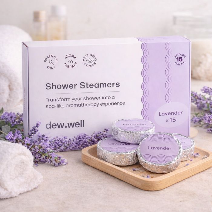Shower steamers with lavender scent by dew.well, designed to create an aromatherapy experience. The package contains 15 tablets and highlights the use of essential oils for stress relief.