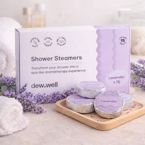 Shower steamers with lavender scent by dew.well, designed to create an aromatherapy experience. The package contains 15 tablets and highlights the use of essential oils for stress relief.