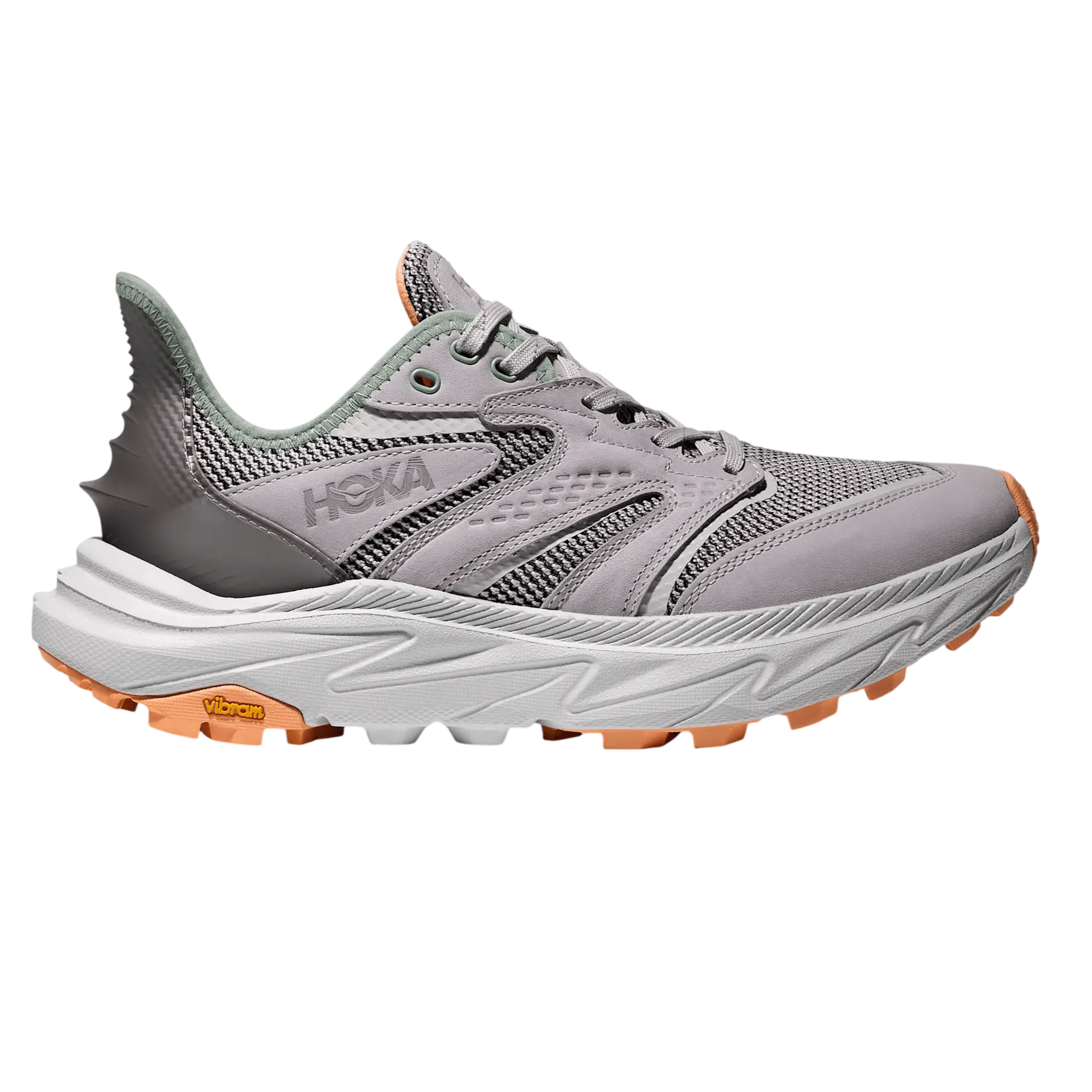 A gray and orange HOKA trail running shoe with a Vibram sole, featuring a mesh upper and reinforced heel.