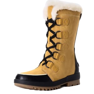 Women's snow boots featuring tan suede, black soles, a faux fur lining, and lace-up front with metal eyelets. Designed for warmth and traction in cold conditions.
