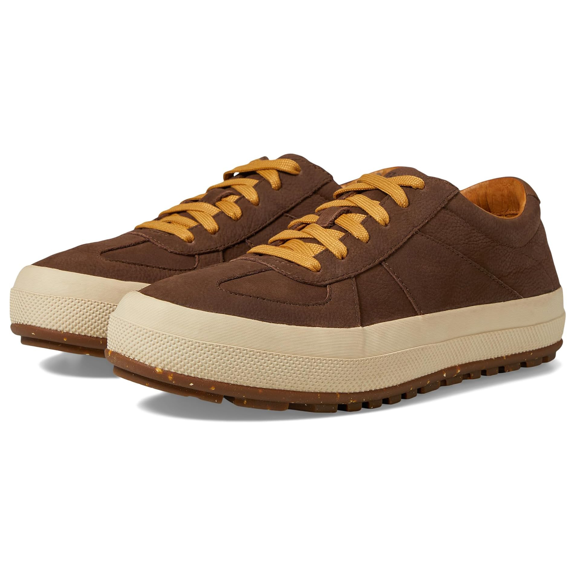 L.L. Bean Men's Double Suede Sneakers feature brown suede uppers, contrasting beige rubber soles, and yellow laces. The soles have a textured design for improved grip.