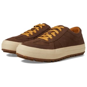 L.L. Bean Men's Double Suede Sneakers feature brown suede uppers, contrasting beige rubber soles, and yellow laces. The soles have a textured design for improved grip.