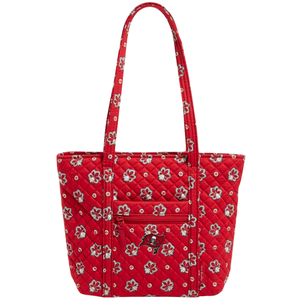 Red quilted tote bag with floral pattern and skull logo on front pocket.