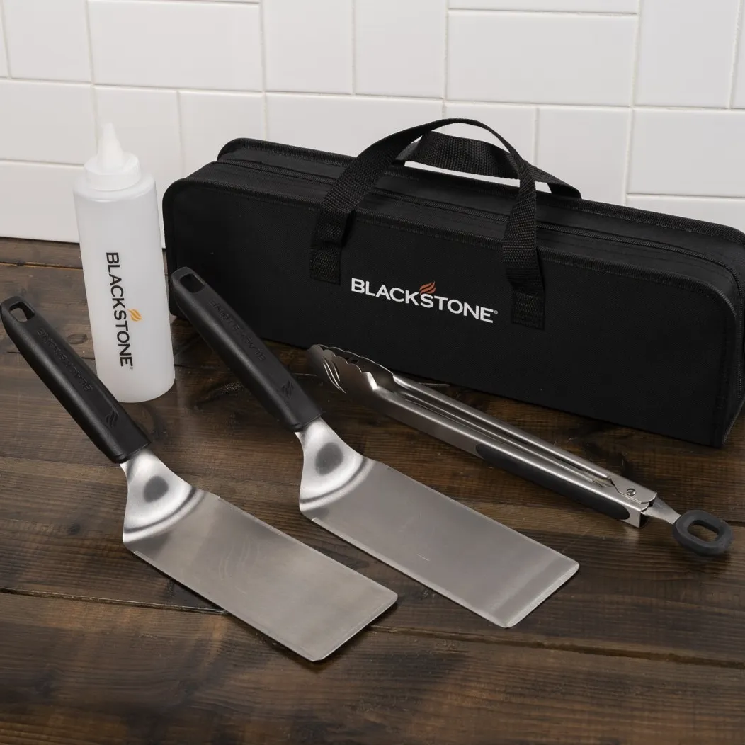 Blackstone griddle tool kit includes two spatulas, a pair of tongs, a squeeze bottle, and a carrying case.