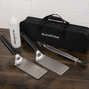 Blackstone griddle tool kit includes two spatulas, a pair of tongs, a squeeze bottle, and a carrying case.