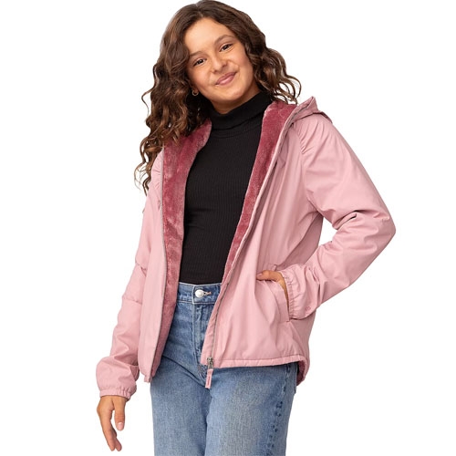 A young girl wears a pink hooded windbreaker with a soft maroon interior lining, paired with a black turtleneck and blue jeans.