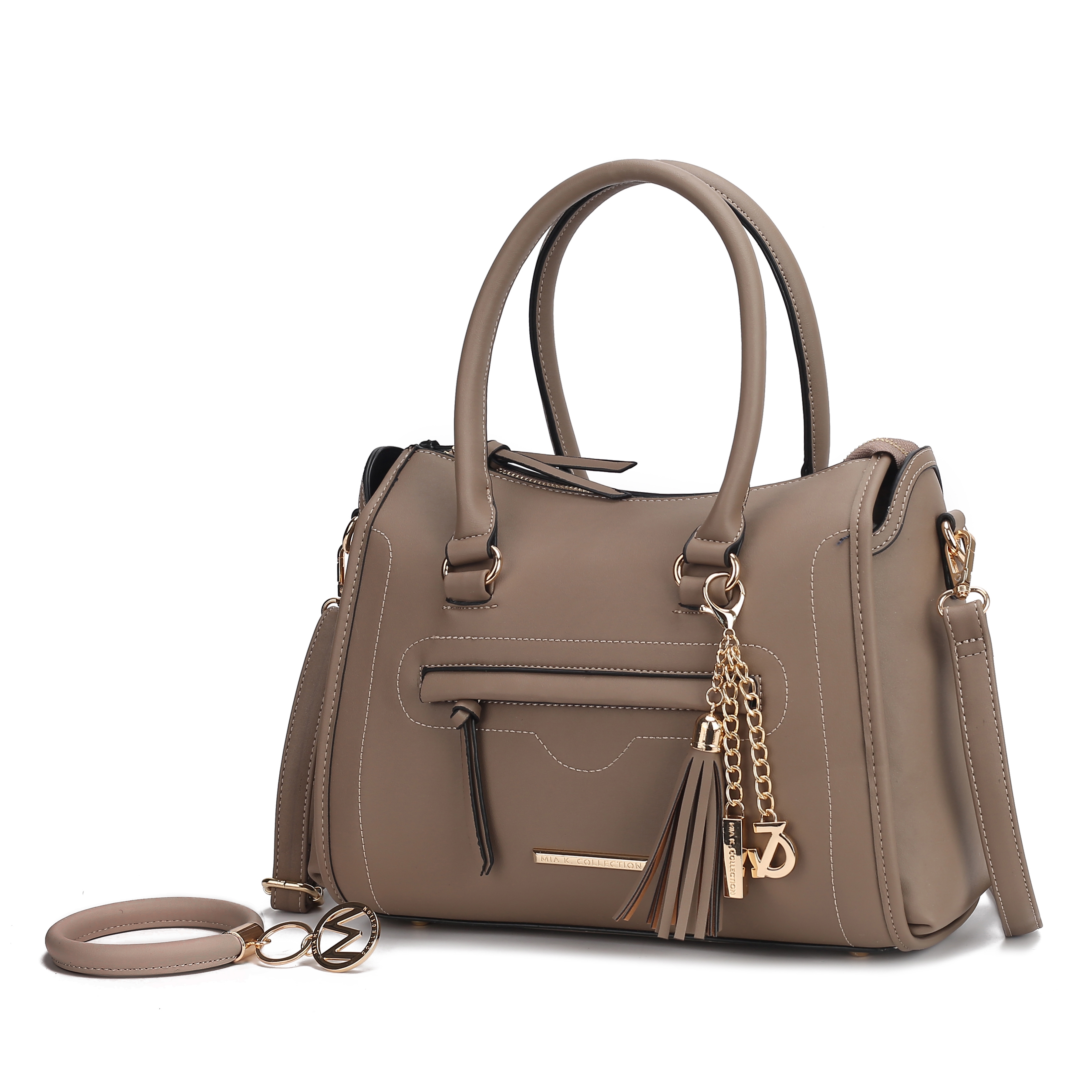 A taupe handbag with dual handles and a detachable strap features gold-tone hardware, a front zipper pocket, tassel detail, and charm chains for decoration.