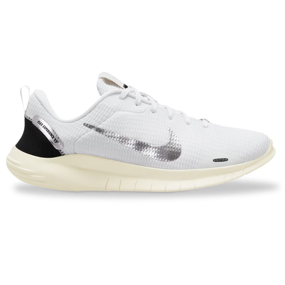 White Nike Flex Experience 12 running shoes with a black heel patch, a silver Nike swoosh on the side, and a cream-colored sole.