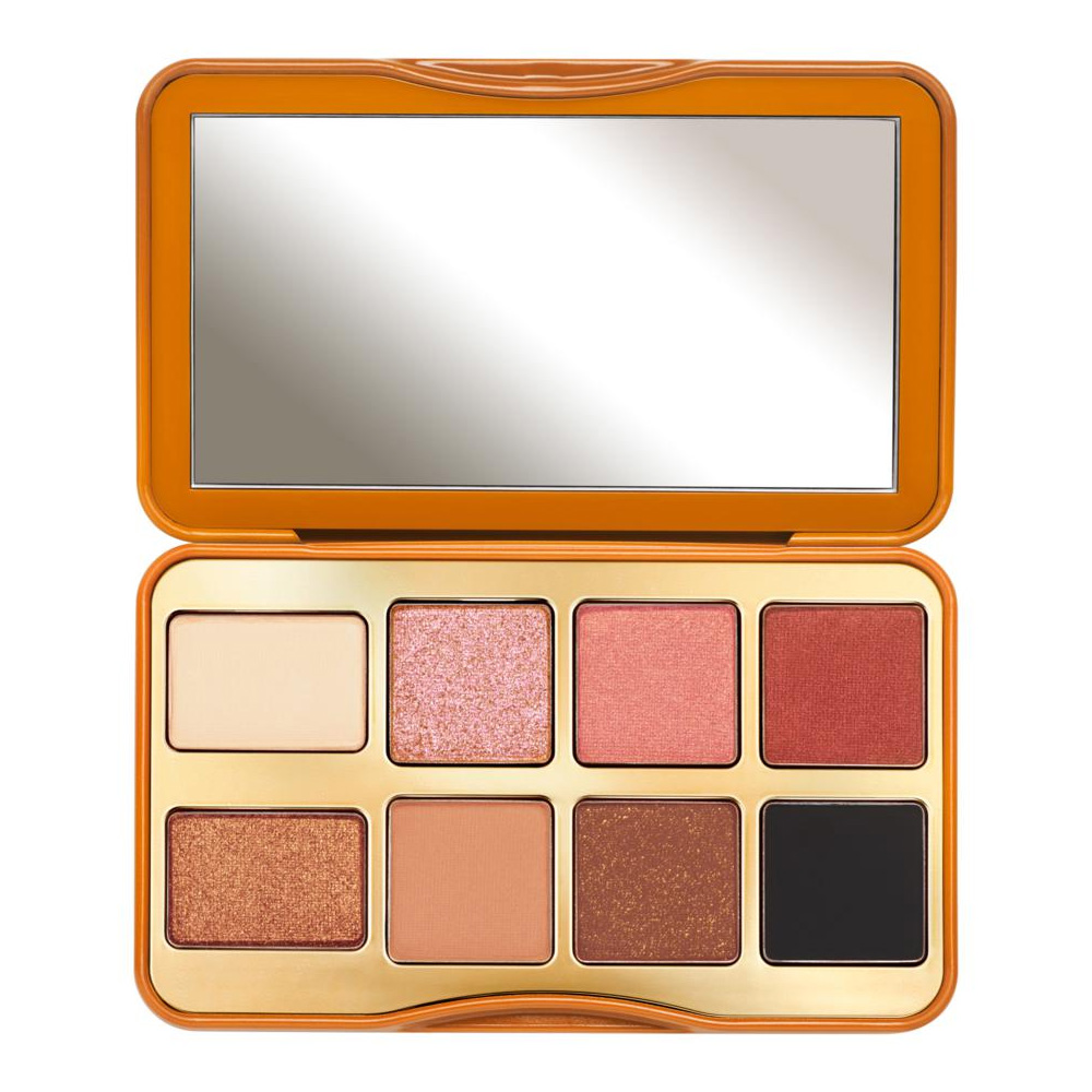 A compact eye shadow palette with eight shades, featuring a mix of matte, shimmer, and glitter finishes, housed in a gold and orange case with a large mirror.